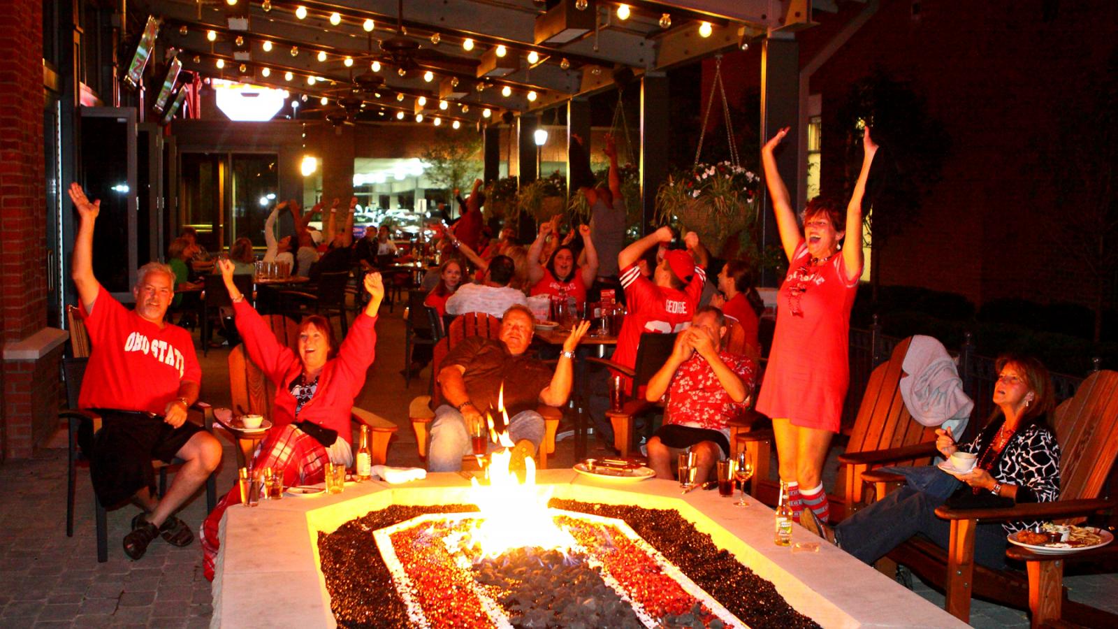 Buckeye Hall of Fame Grill firepit with people Photo Credit: Buckeye Hall of Fame Grill
